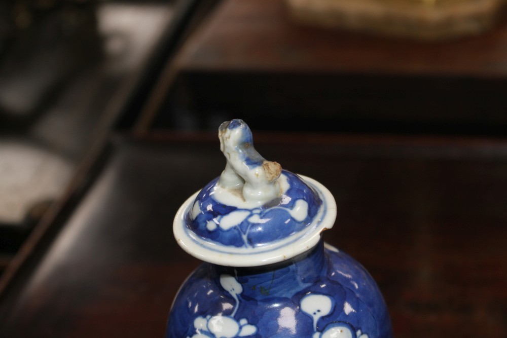 An 18th century Chinese export teapot and a pair of prunus pattern vases and covers